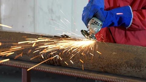 Worker using industrial grinder. 4K Video stock 86977345