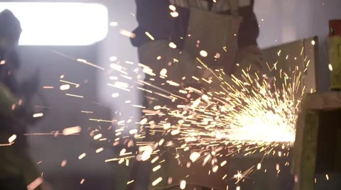Worker using industrial grinder on metal parts in industrial workshop warehouse Stock Footage 63313731