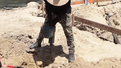 Worker using jackhammer on ground Stock-Footage 228794745