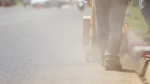 Worker using machine to cut the asphalt road Stock Footage 91276708
