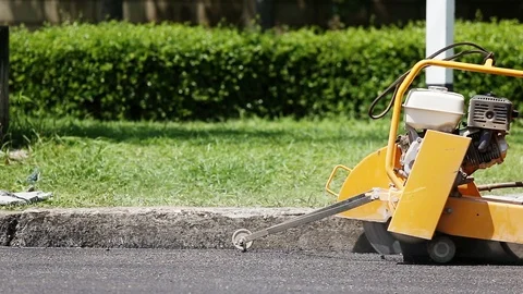 Worker using machine to cut the asphalt road Stock Footage 91276720