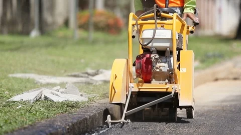 Worker using machine to cut the asphalt road Stock Footage 91276762