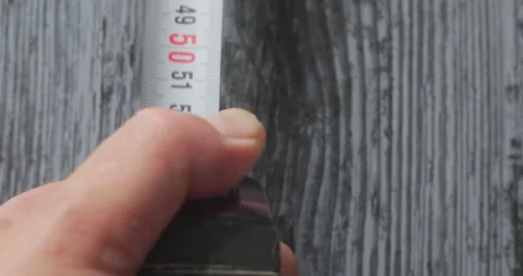 Worker using measuring tape on wooden surface Stock Footage 318300068