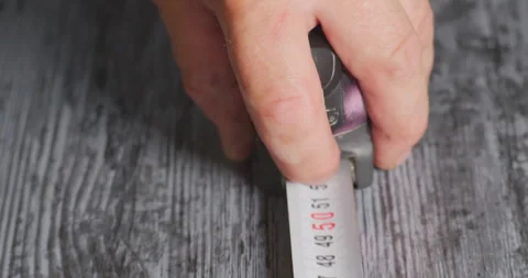 Worker using measuring tape on wooden surface Stock Footage 327128121