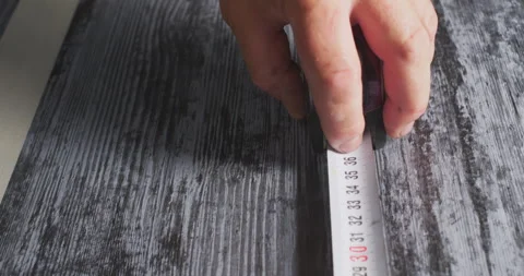 Worker using measuring tape on wooden surface Stock Footage 327128193