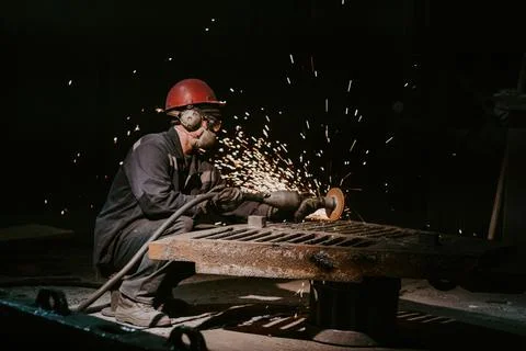 A Worker Using A Metal Grinder Stock Photos