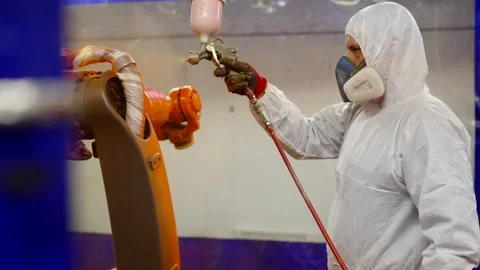 Worker using a paint spray gun Stock Footage 258075904