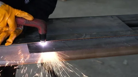 Worker Using Plasma Cutter to Slice Through Iron Plate Stock Footage 339239154
