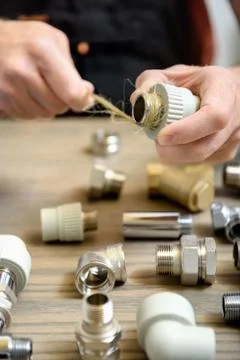 The worker is using a plumber's hemp fibers. Stock Photos