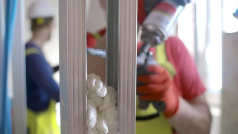 Worker using polyurethane foam for gluing drywall frame Stock Footage 133635258