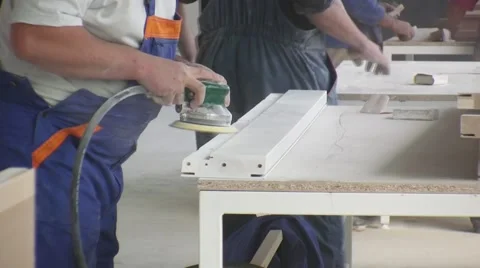 Worker using a power sander to smooth part of the doors frame. Stock Footage 57219666