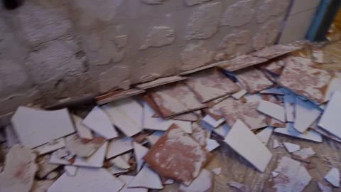 Worker using power tool demolishing wall tiles 스톡 동영상 346958780