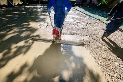 Worker is using power tool with engine, compactor, for level and compact Stock Photos