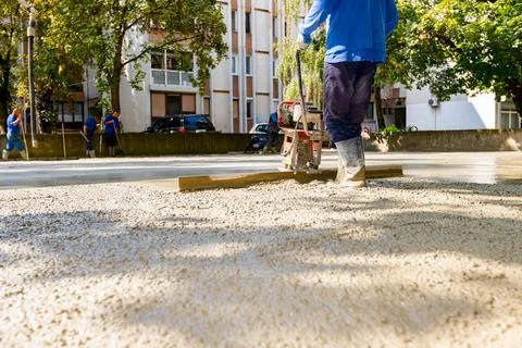 Worker is using power tool with engine, compactor, for level and compact Stock Photos