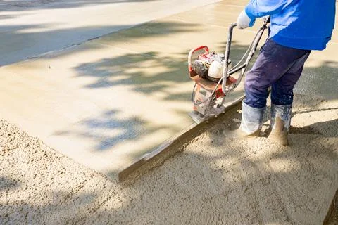 Worker is using power tool with engine, compactor, for level and compact Stock Photos