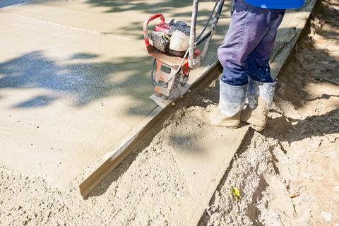 Worker is using power tool with engine, compactor, for level and compact Stock Photos