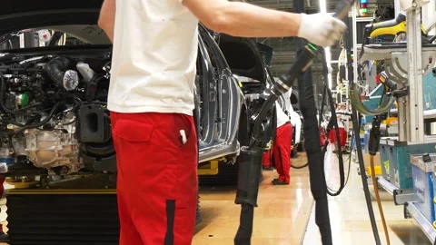 Worker Using Production Equipment on Car Assembly Line Video stock 346226528