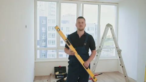 Worker using a ruler with a water level. Construction builder working with water Stock Footage 232170702