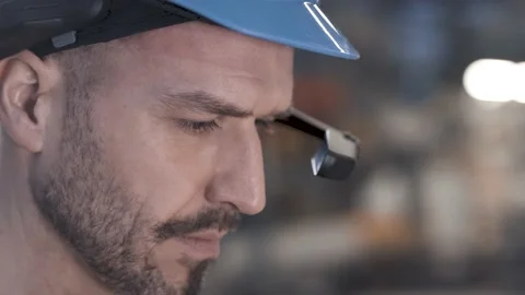 Worker using smart augmented reality goggle device in industrial hall company Stock Footage 149296422