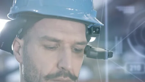 Worker using smart augmented reality goggle device in industrial hall company Stock Footage 149297547