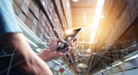 Worker using  smartphone application checking on global logistics Fotos de archivo