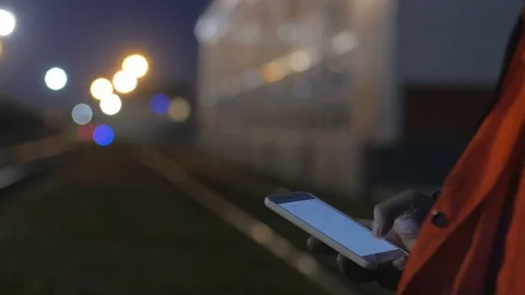 Worker using smartphone during night shift. 4k close up Video stock 83760913