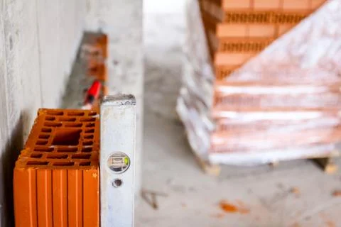 Worker is using a spirit level to control wall Stock Photos