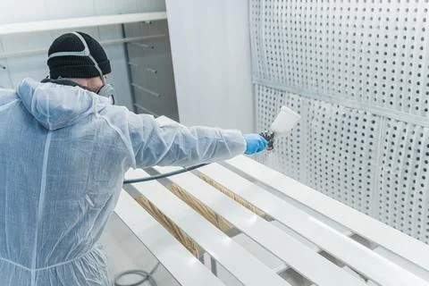Worker using spray gun and painting wood. Application of flame retardant Stock Photos