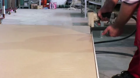 Worker using staple gun to fix back side of the closet in furniture factory. Vídeo Stock 57216739