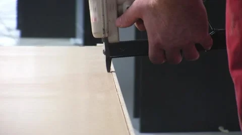 Worker using staple gun to fix back side of the closet in furniture factory. Video stock 57216819