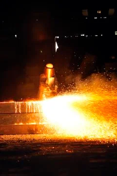 Worker using torch cutter to cut through metal Stock Photos