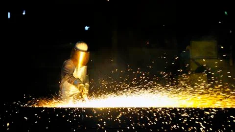 Worker using torch cutter to cut through metal Stock Photos
