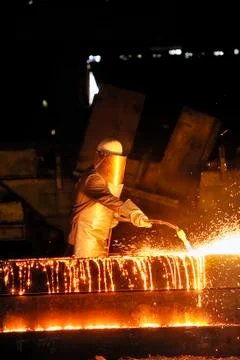 Worker using torch cutter to cut through metal Stock Photos