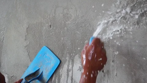 Worker using trowel to finish wet concrete wall at construction site  Stock Footage 112949529