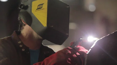 Worker Using a Welding Torch to cut Metal Stock Footage 63873163