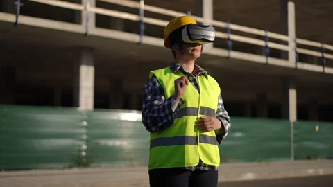 Worker Utilizing Advanced VR Technology on a Work Site for Various Applications Stock Footage 311861311