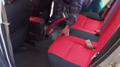 A worker vacuums the car interior Stock Footage 106029884