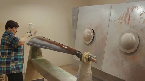 Worker varnishing the harp Stock Footage 79835079