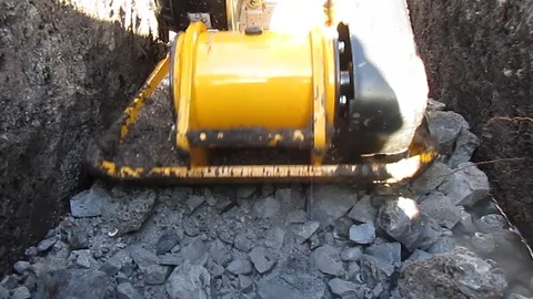 Worker with vibrating plate compactor machine. Video Clip. Stock Footage 102166853