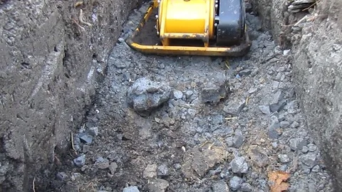 Worker with vibrating plate compactor machine. Video Clip. Stock Footage 102167015