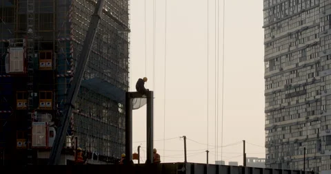 Worker waits at top of building Видео 224342863