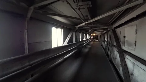 Worker walk through a dark corridor at a metallurgical plant. POV 스톡 동영상 106450310