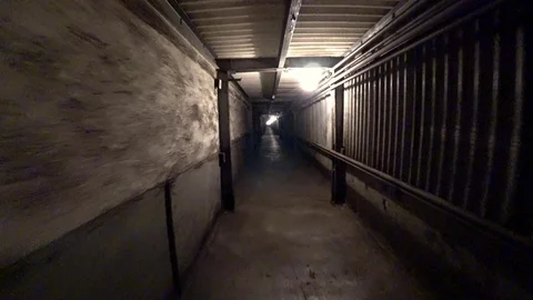 Worker walk through a dark corridor at a metallurgical plant. POV 스톡 동영상 106450320
