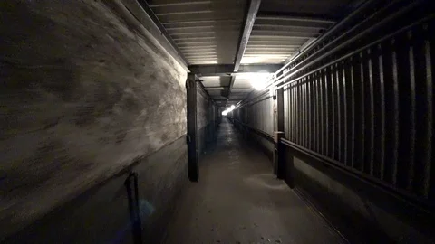 Worker walk through a dark corridor at a metallurgical plant. POV Vídeos de archivo 106450368
