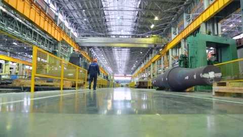 Worker walking along a walkway in a machine works Stock Footage 100332648