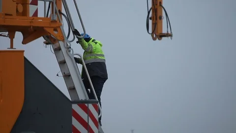 Worker Walking Down the Ladder and Leaving the Crane Stock Footage 72189201