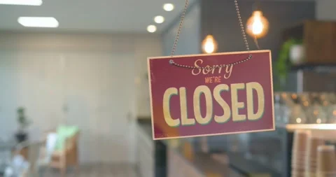 Worker walking into frame toward closed sign, flipping sign to open coffee shop Stock Footage 340964343