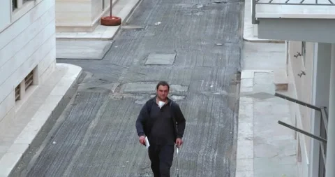 A worker is walking with the measuring wheel, measure the road 動画素材 247627831