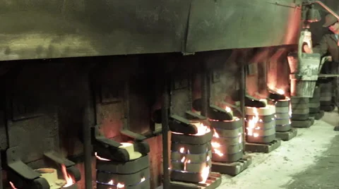 Worker walking near burning pressed sand forms Stock Footage 62083482