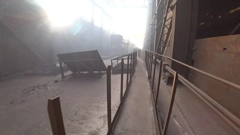 Worker walking on a polluted graphite-covered roof of old steel plant. Video stock 106450459